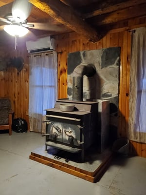 Photo of a woodstove inside Jon's hunting camp